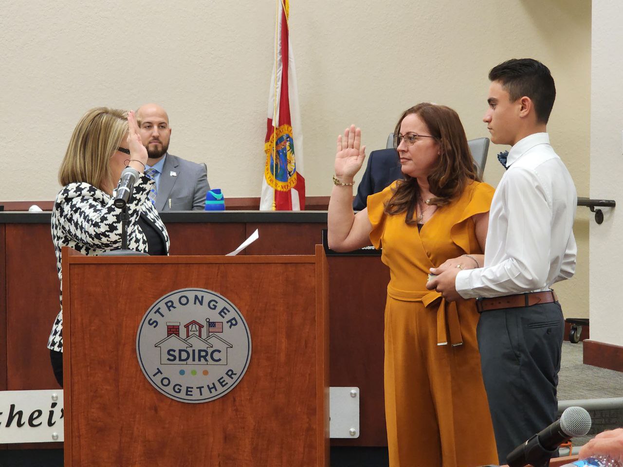 Judge Victoria Griffin administering oath of office to Dr. Gene Posca. Rosario's son Nicholas Rosario is holding a bible