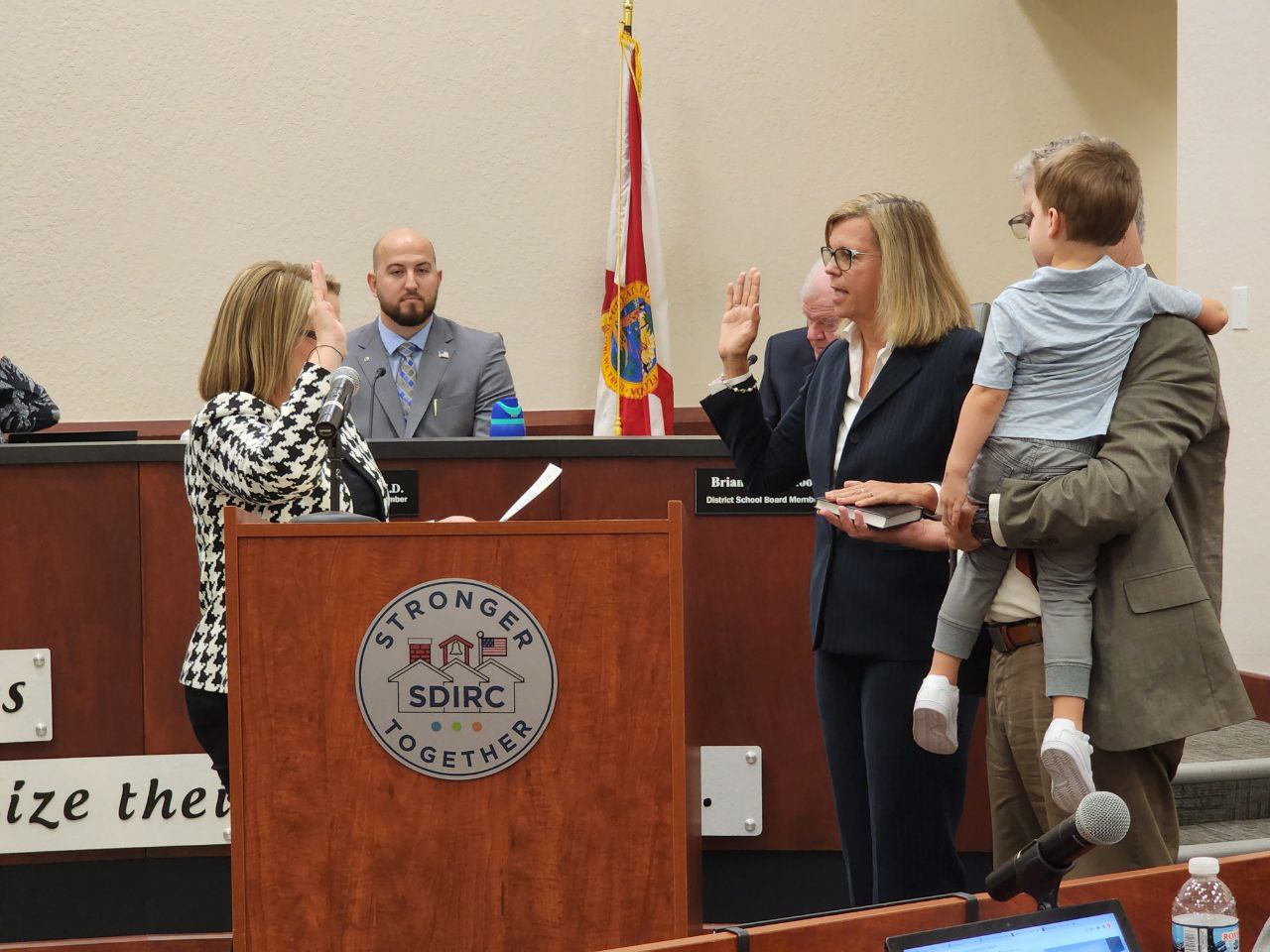 Judge Victoria Griffin administering oath of office to Teri Barenborg. Barenborg's husband Ed Barenborg is holding a bible in his right hand and is shown in the picture holding his Grandson
